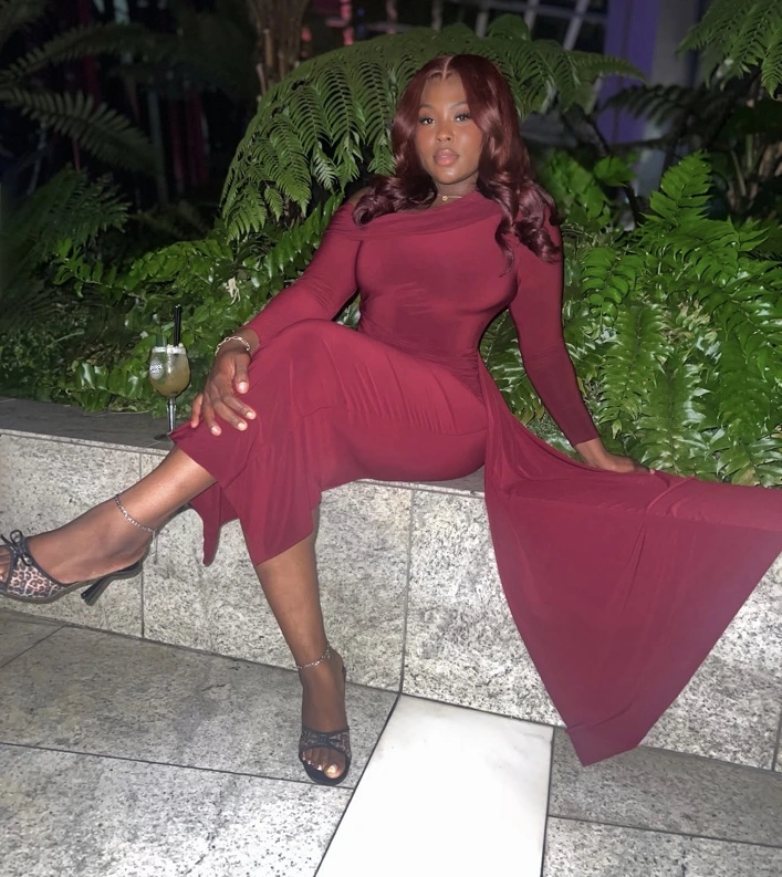 Shay Wig Master, founder of The Pretty Mob, wearing a burgundy dress at Sky Garden